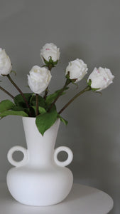 Short Clip of Artificial White Rose Buds in a Vase