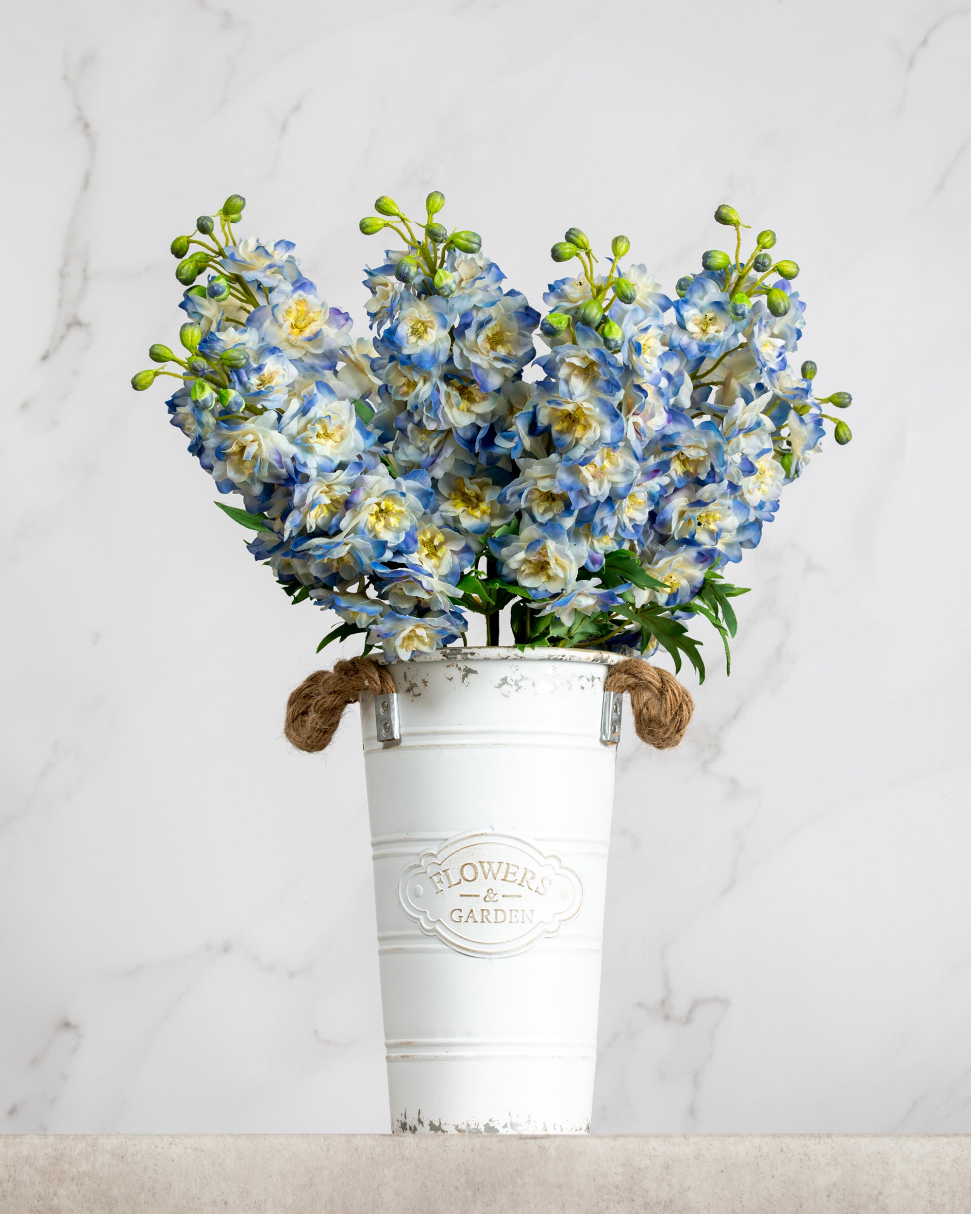 Prestige Botanicals Artificial blue delphiniums in a white tin vase