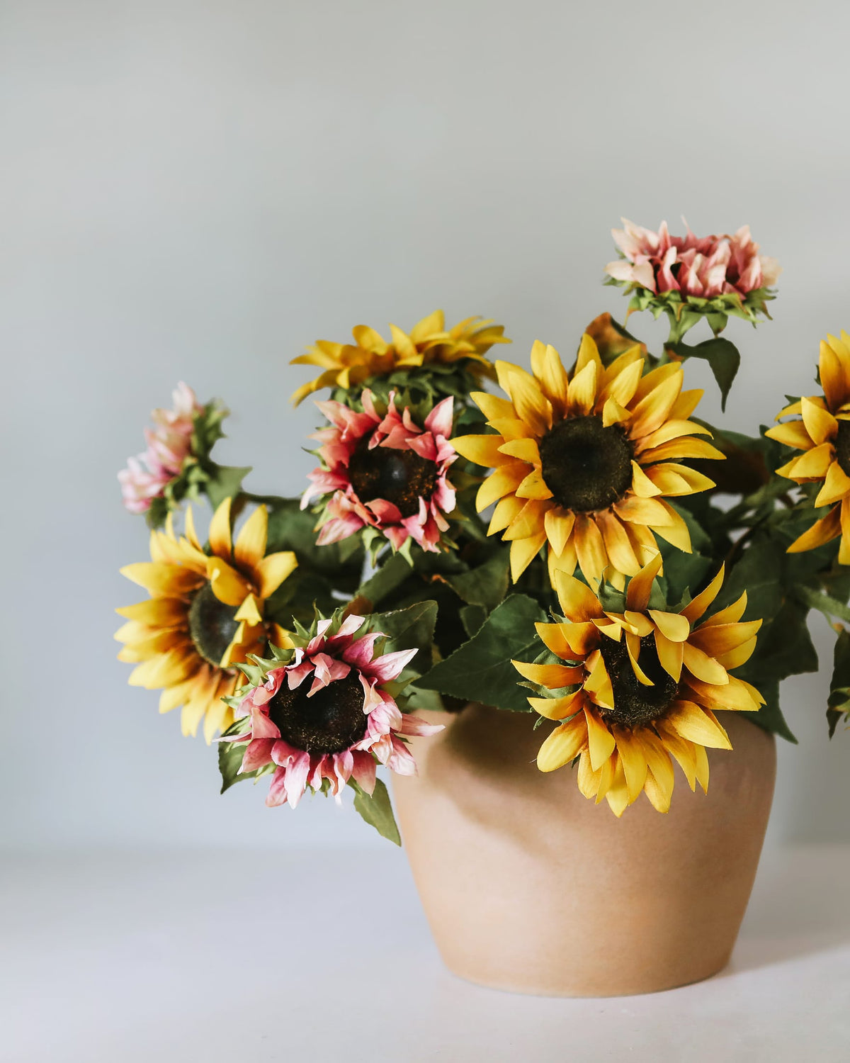 Faux yellow and purple Sunflowers in a vase