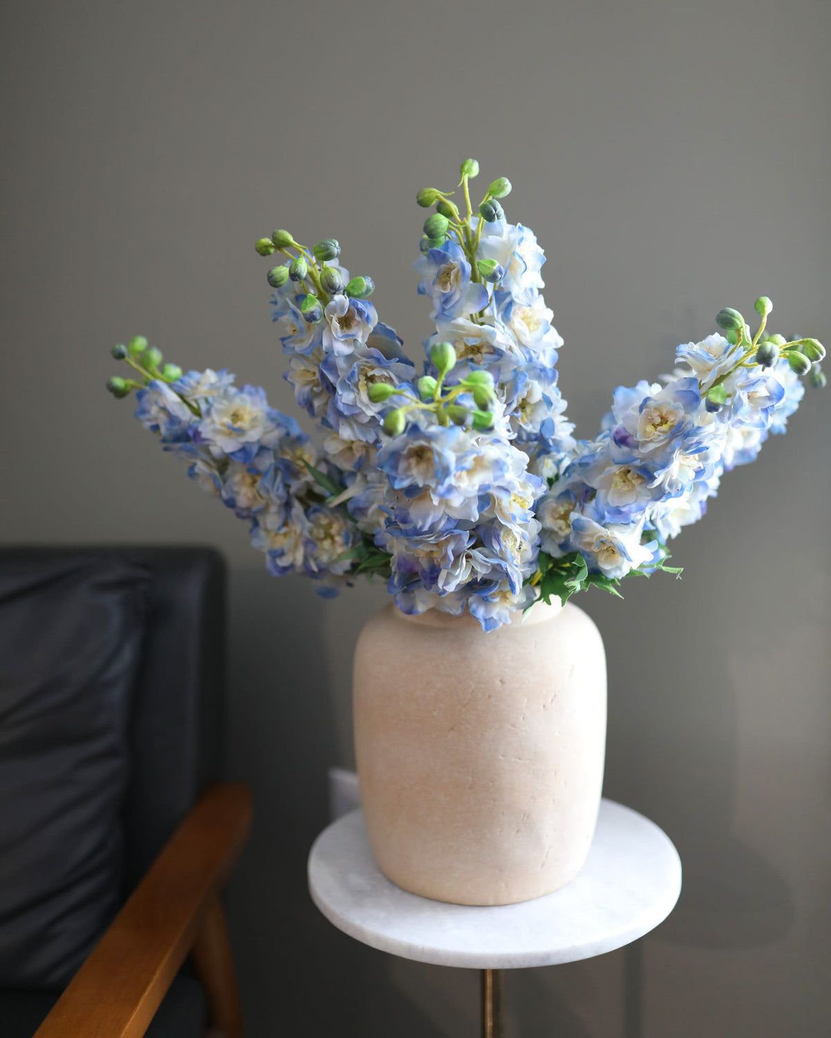 artificial blue delphiniums in a vase 