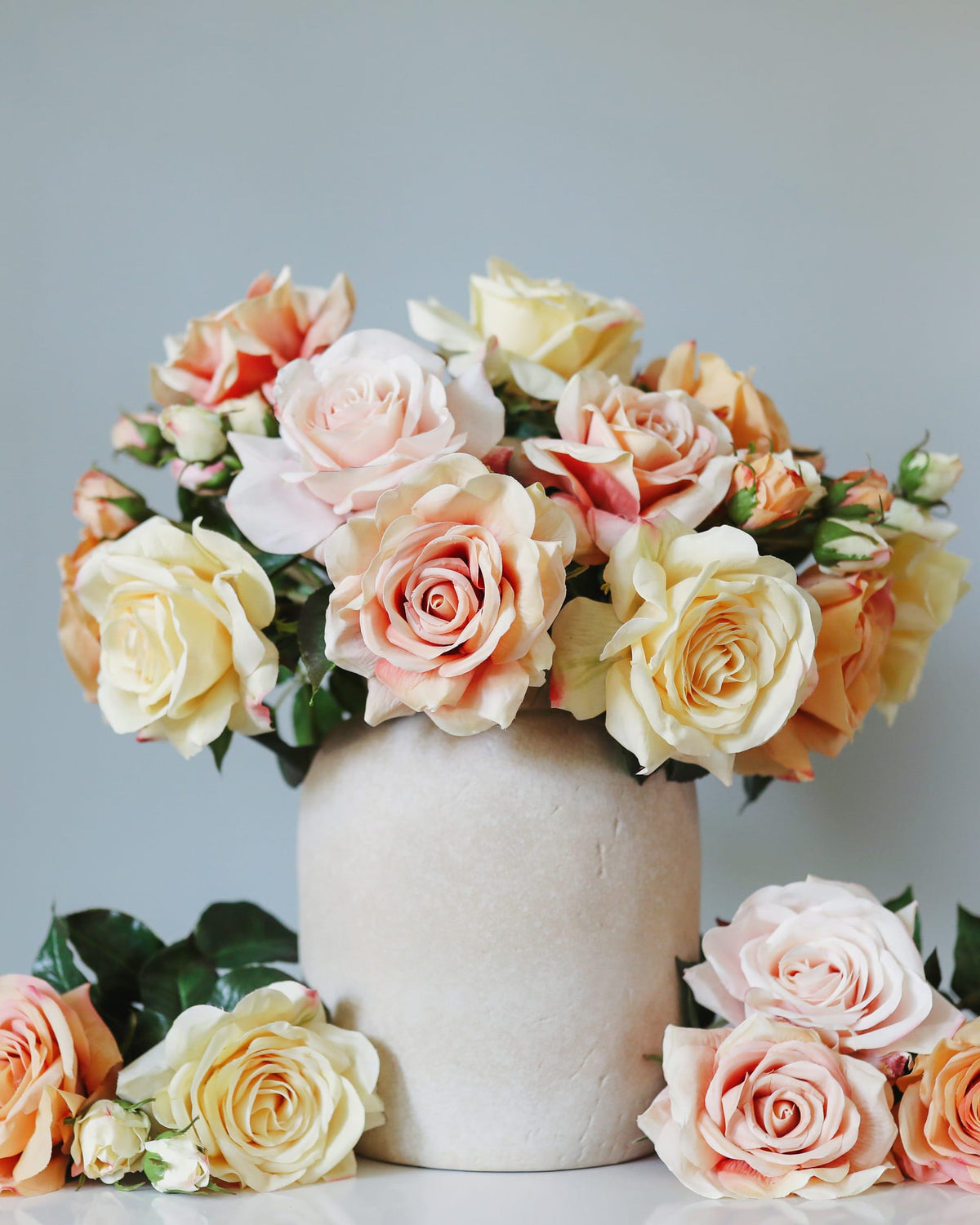 mixed color artificial real touch roses in a vase
