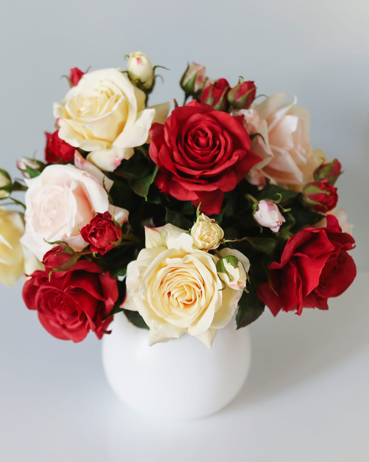 mixed color real touch faux roses in a vase