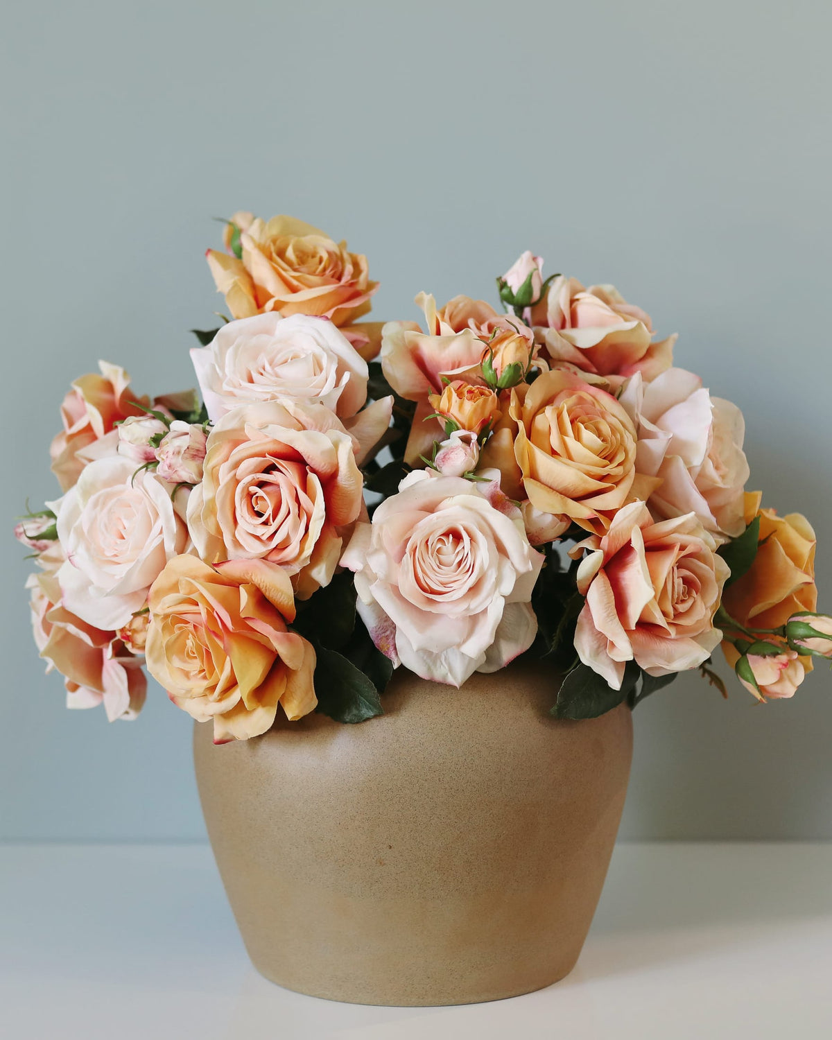 faux pink and orange roses in a vase