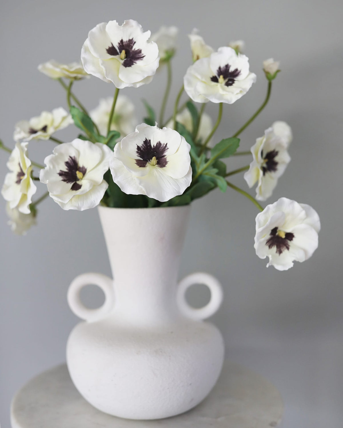 Artificial White Pansies in a vase