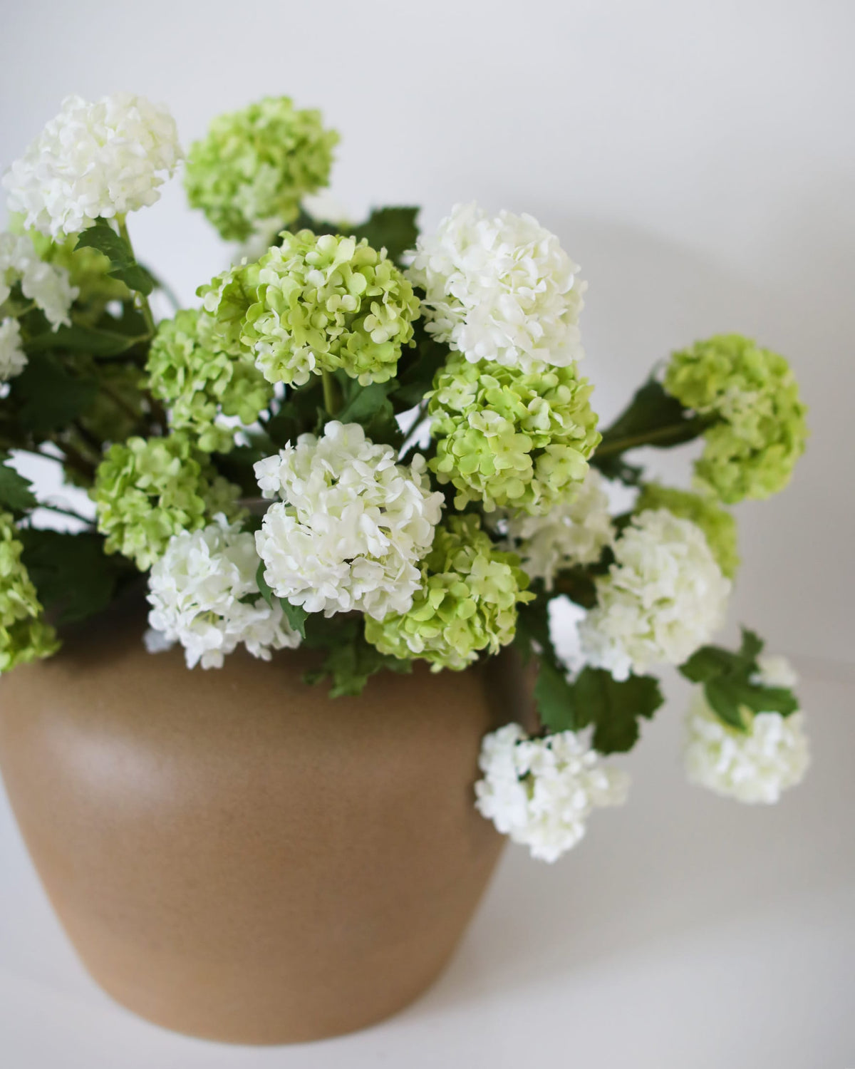 Faux Green and white Snowballs in a vase