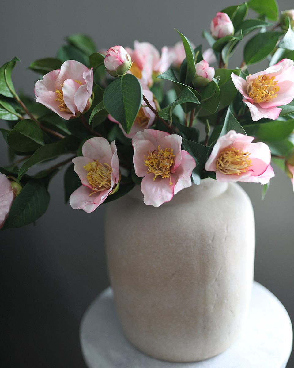 Close Up Image of Fake Pink Camellias in Vase