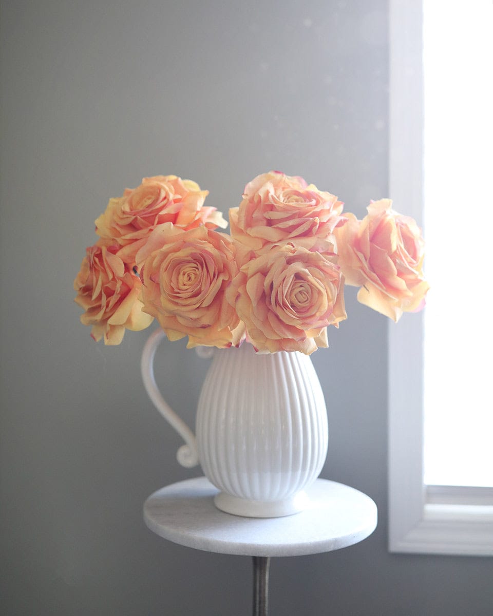 Pitcher Vase Filled with Artificial Orange Roses