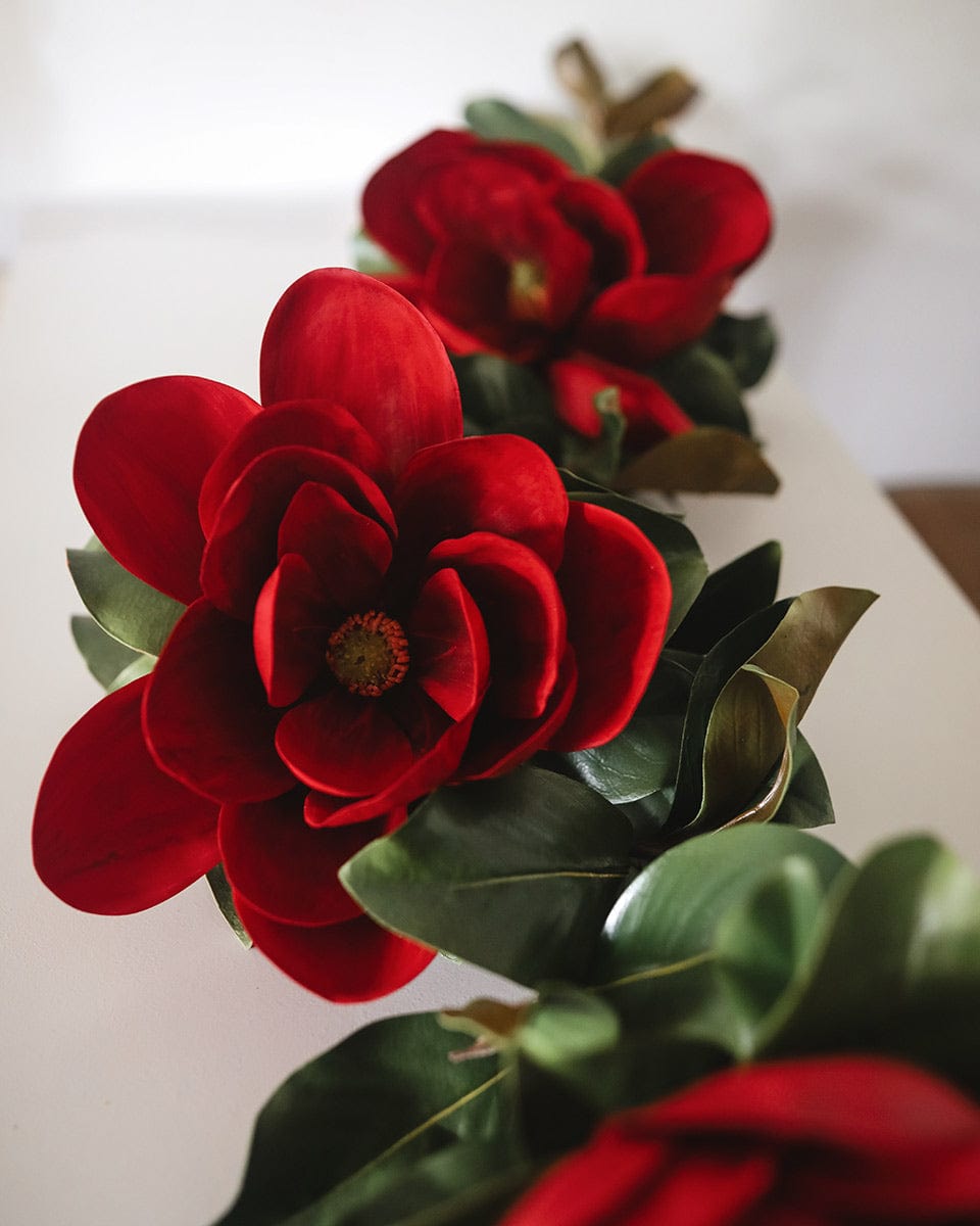 Fake Red Magnolias Styled in Faux Magnolia Leaf Garland