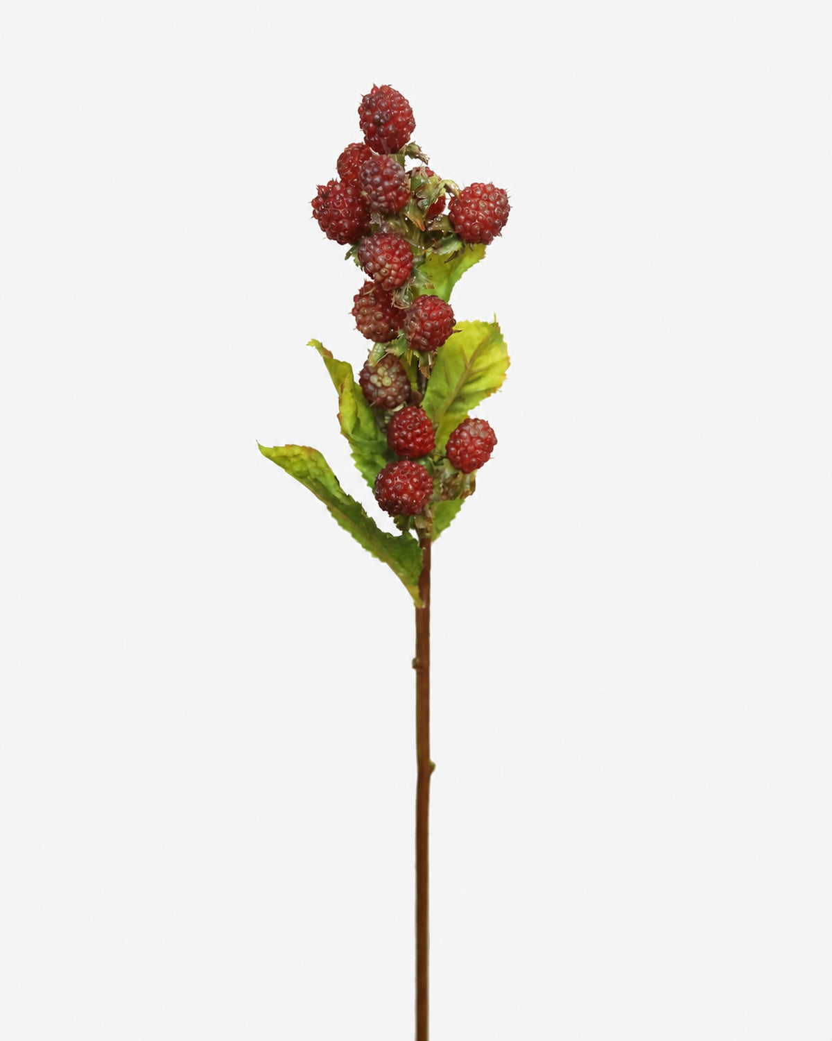 An artificial raspberry on a solid light gray background.