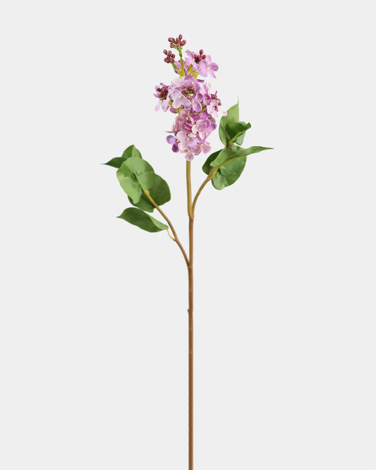 Artificial lilac stem with pink flowers and green leaves on a white background