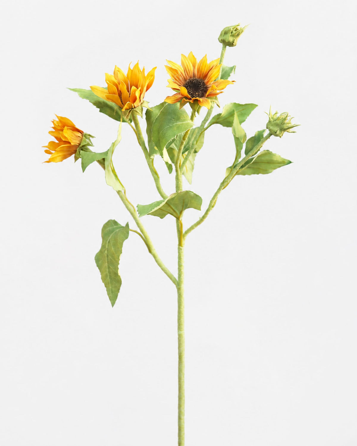 A single artificial sunflower stem with three yellow-orange flower heads, green leaves, and closed buds on a plain light gray background.