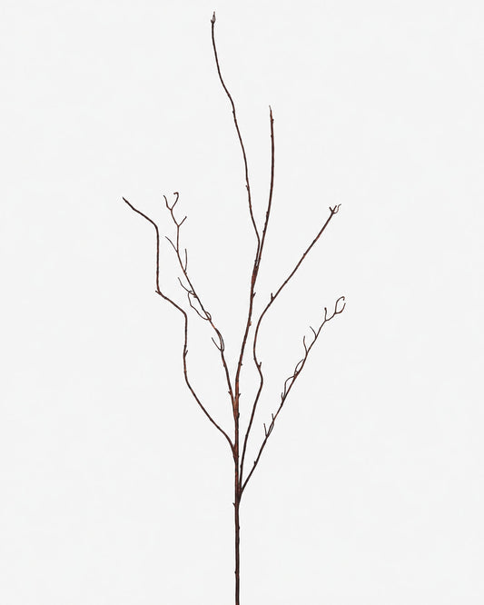 A single bare decorative faux branch with thin brown twigs and small buds, photographed against a plain light gray background.