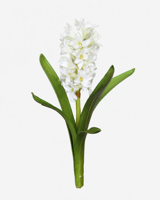 A single white fake hyacinth flower with a green stem and leaves, isolated on a light gray background.