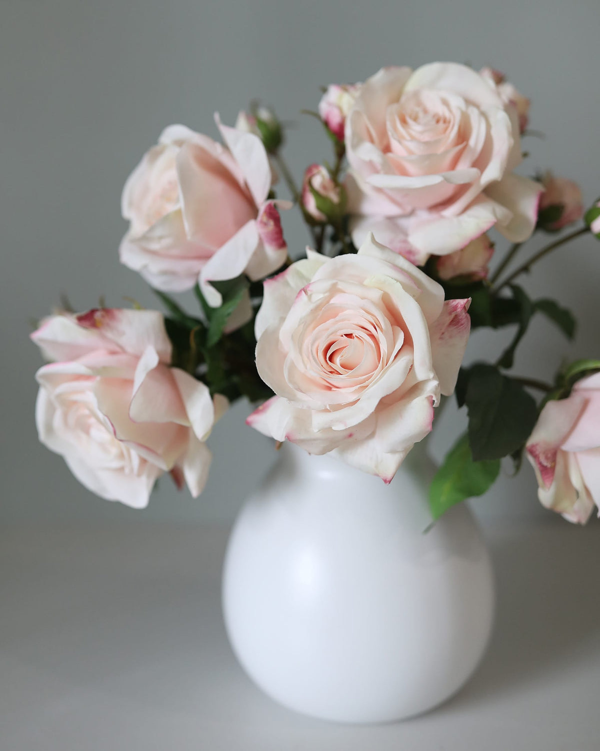 Faux Real Touch Pink Roses in a vase close up 