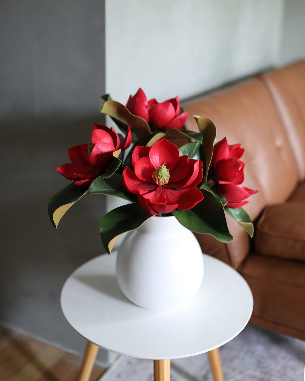 Red artificia Magnolia Blooms in a vase