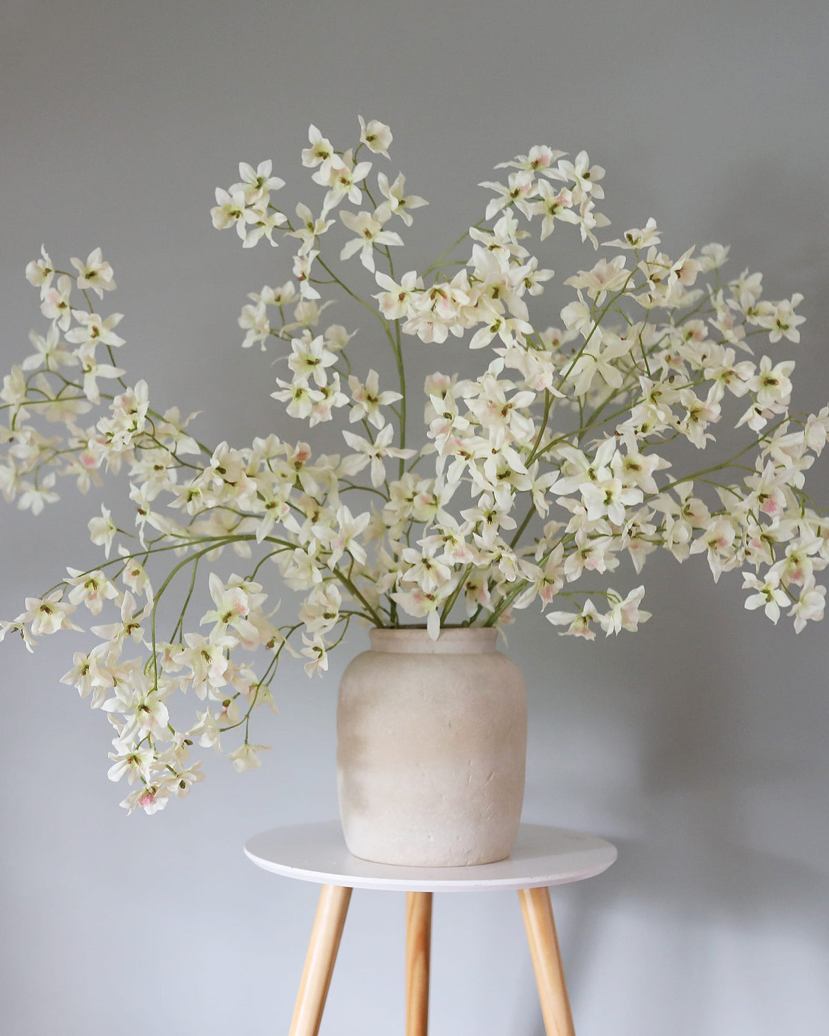 Artificial White Oncidium orchids in a vase