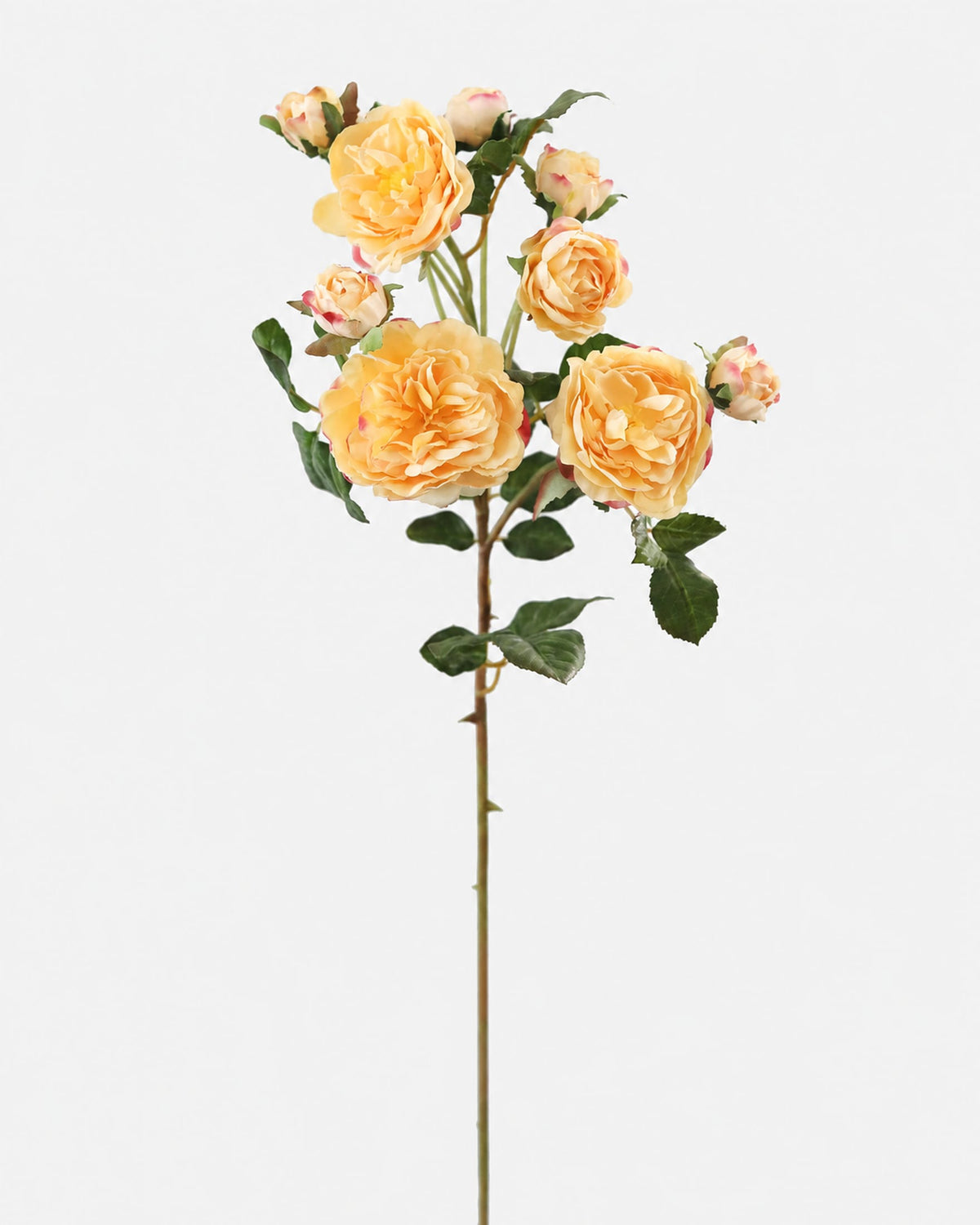A single artificial rose stem featuring pale yellow-orange roses, green leaves, and buds on a plain light gray background.