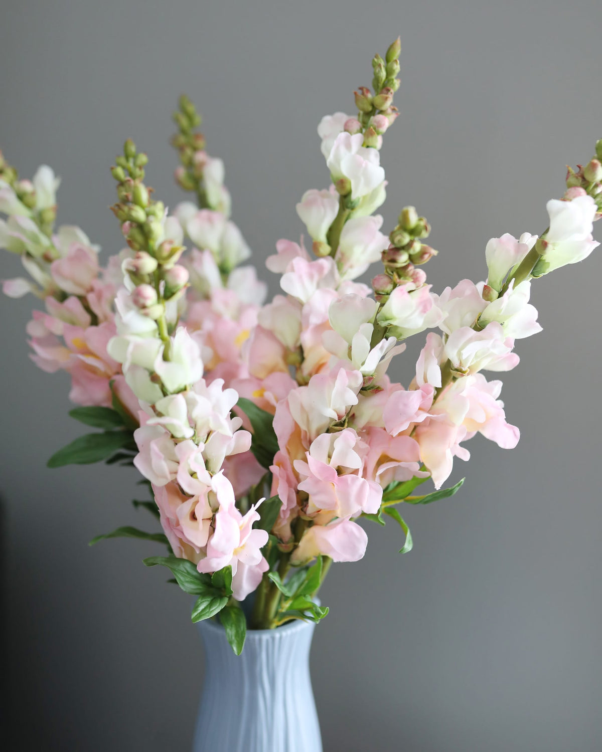 faux pink snapdragons in a vase