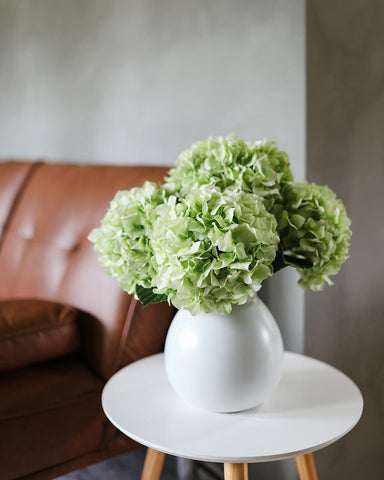 real touch hydrangeas faux florals for dining table, eucalyptus branches in vase, potted pothos on dining table
