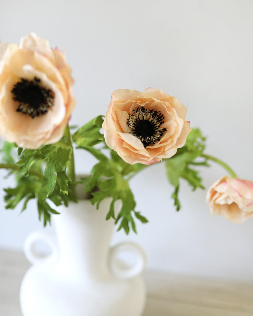 Close Up Photo of Artificial Anemones in Vase