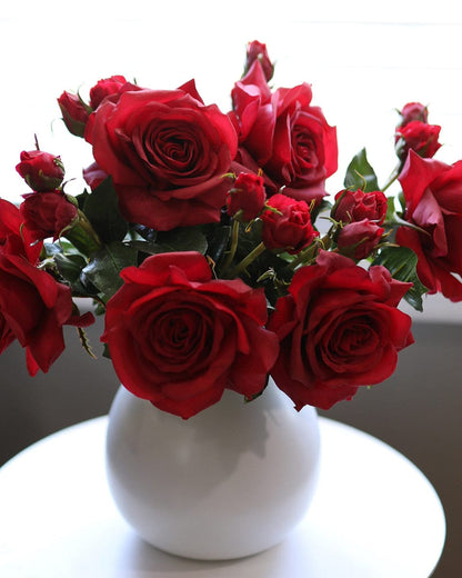 Close Up Details of Red Prestige Roses Arranged in a Vase