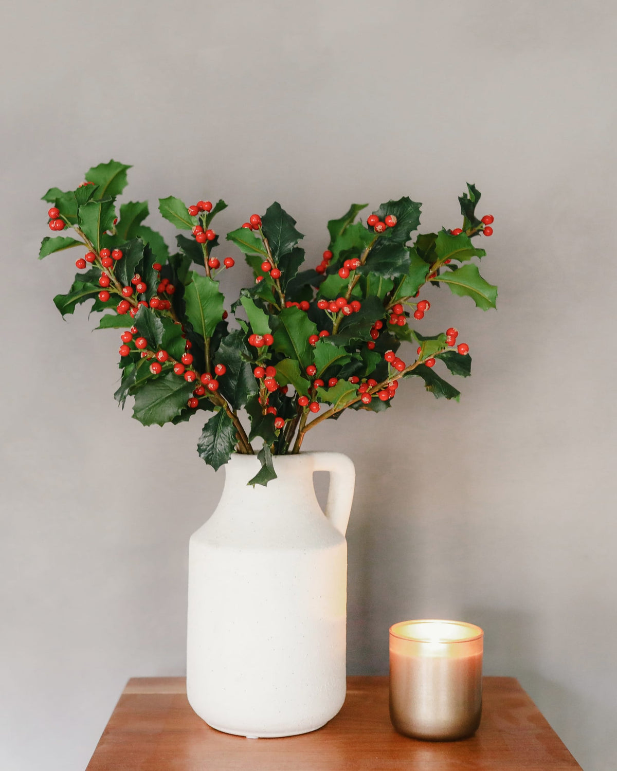faux holly stems in a vase