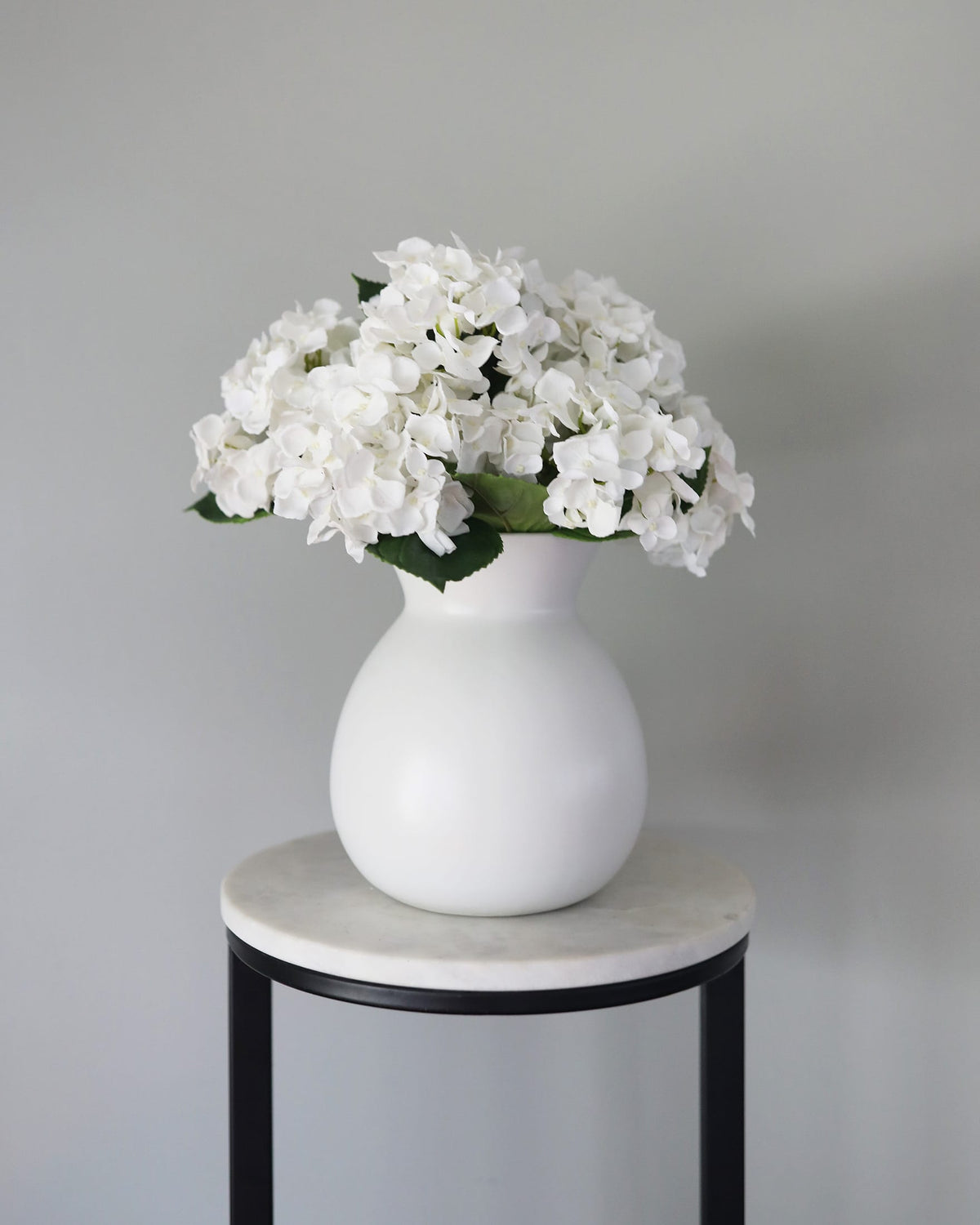 Artificial white hydrangeas in a vase