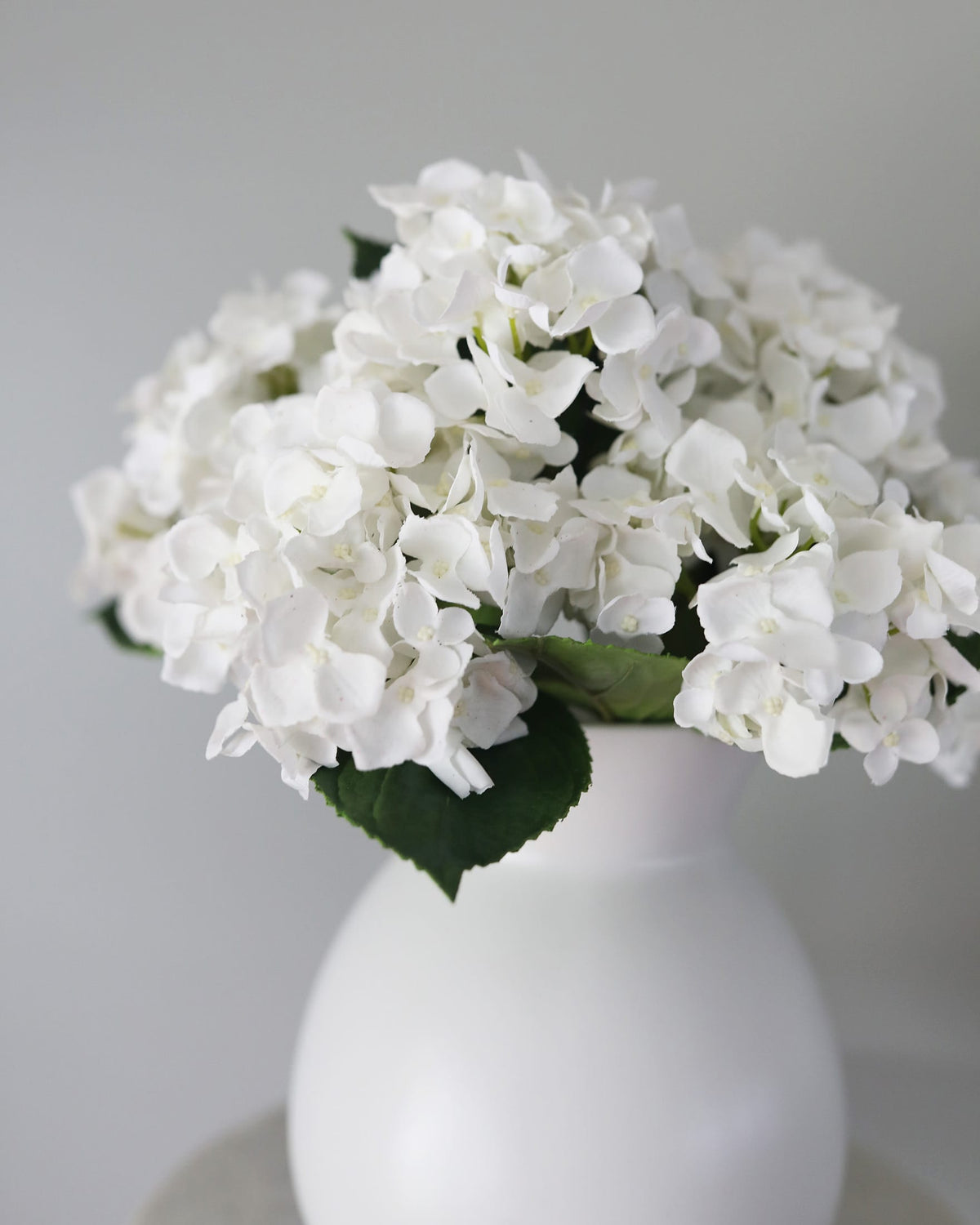 Artificial white hydrangeas in a vase