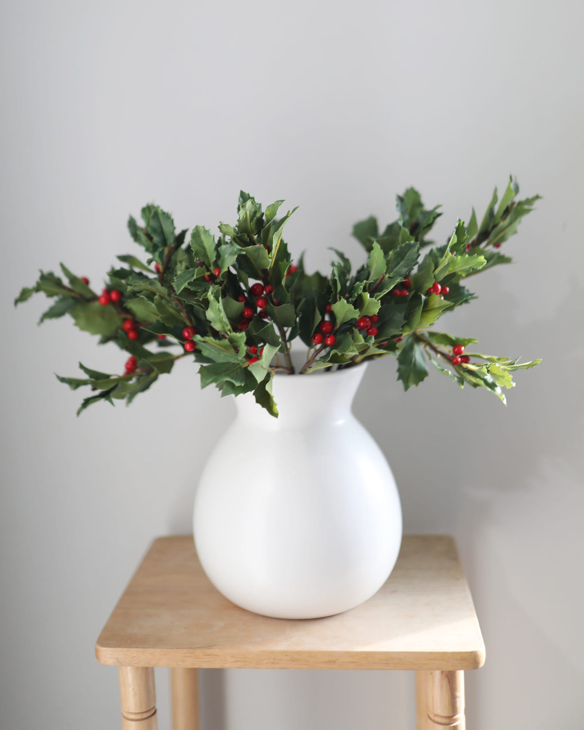 faux holly in a vase