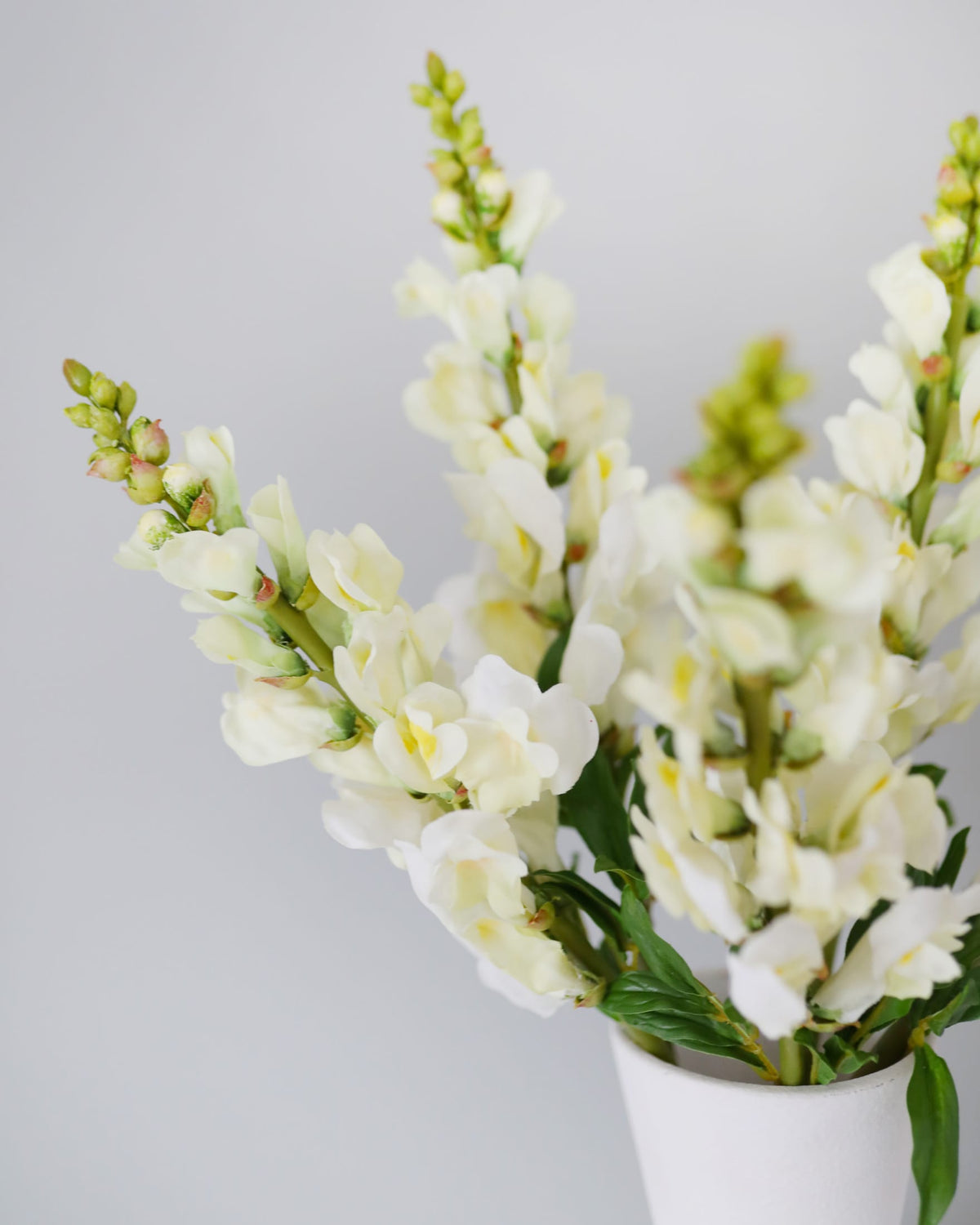 faux yellowish snapdragons close up