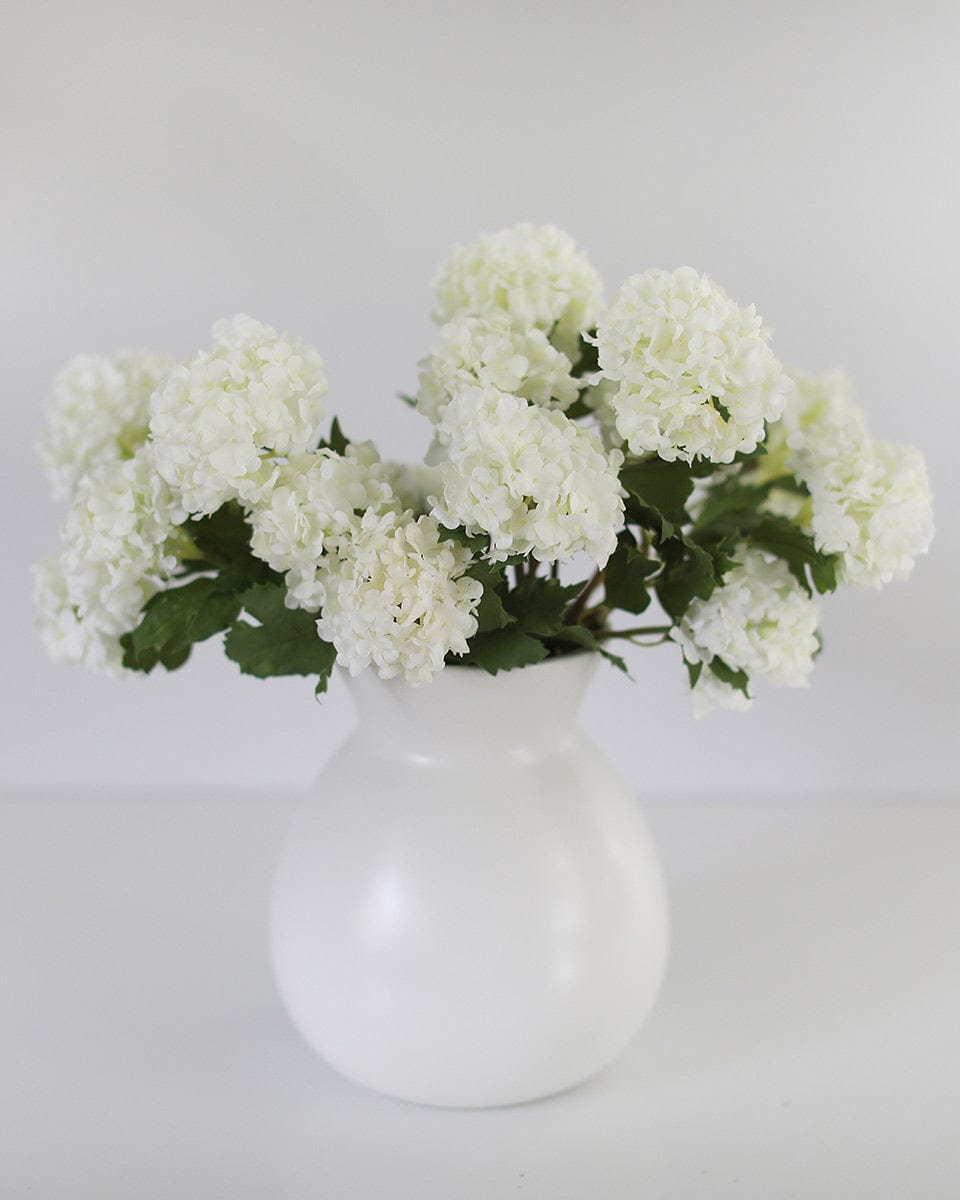 Fake White Snowball Blossoms in White Vase