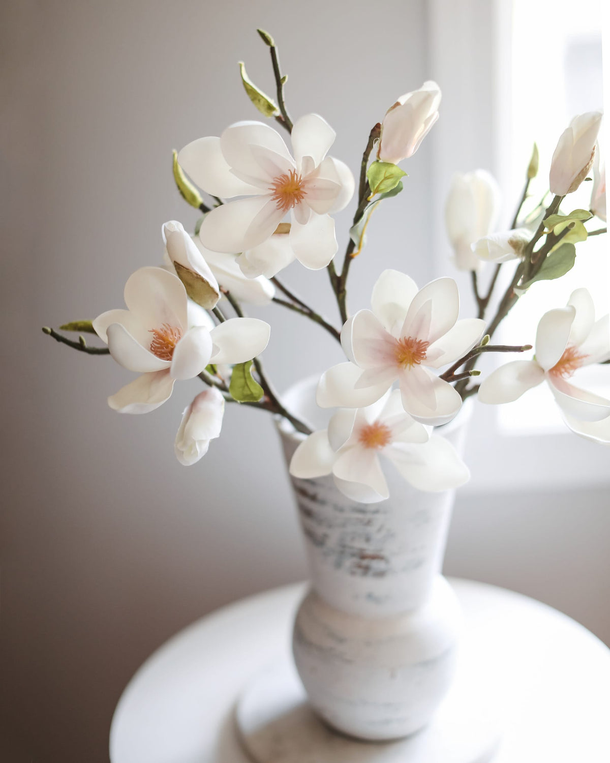 white faux magnolia tulips in a vase