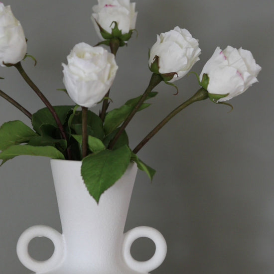 Short Clip of Artificial White Rose Buds in a Vase