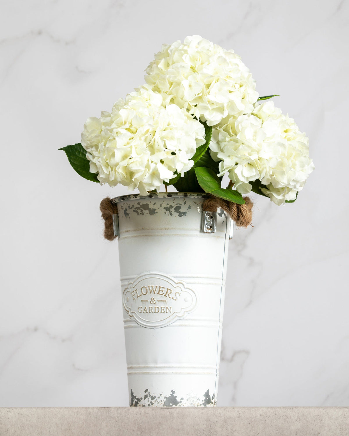 Prestige Botanicals Artificial White Hydrangea stems in a white tin vase